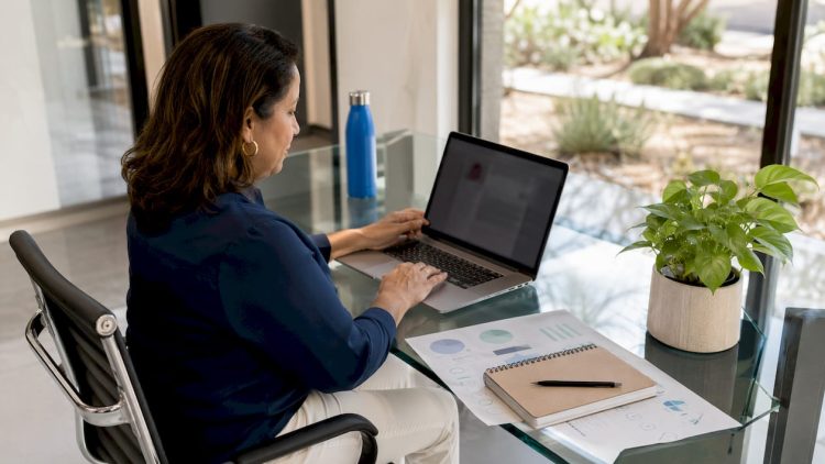 Woman optimizing Google Business Profile on laptop