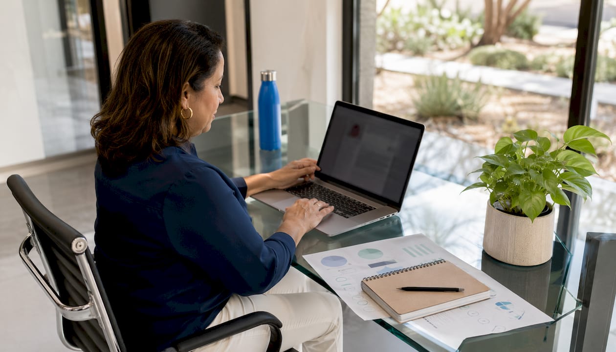 Woman optimizing Google Business Profile on laptop