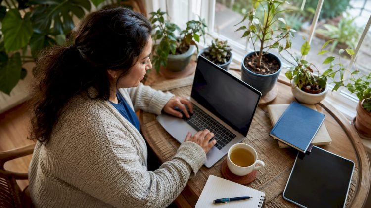 Small business owner managing online reviews on laptop