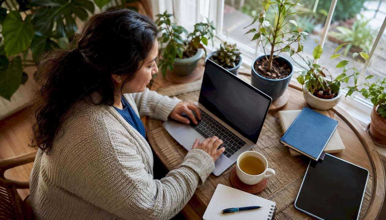 Small business owner managing online reviews on laptop