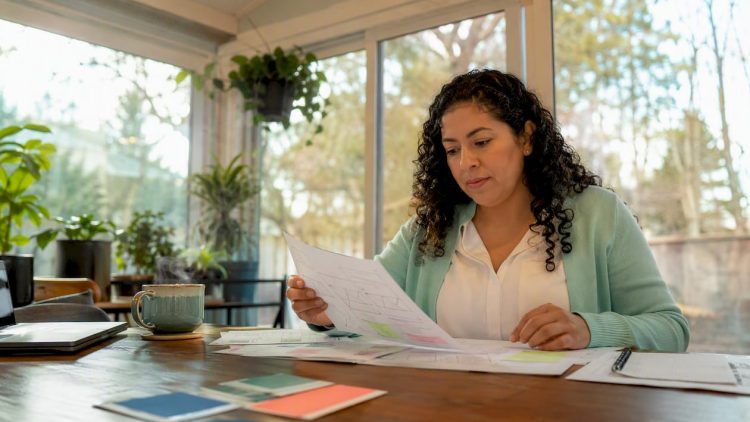 Woman reviewing small business web design drafts