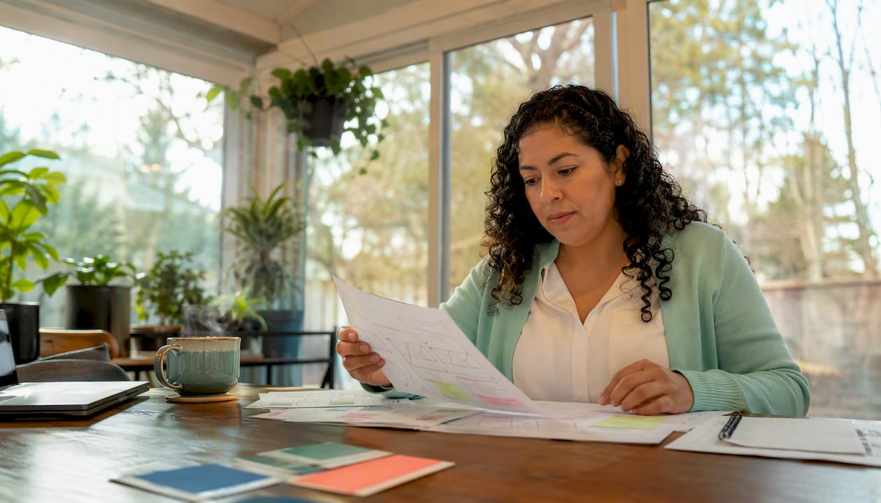 Woman reviewing small business web design drafts