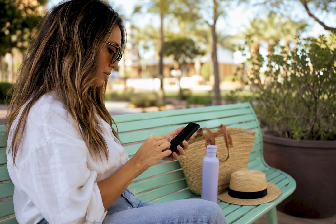 Small business owner testing PPC keywords on smartphone