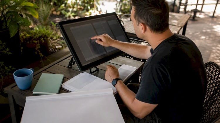 Hands adjusting web design layout grids