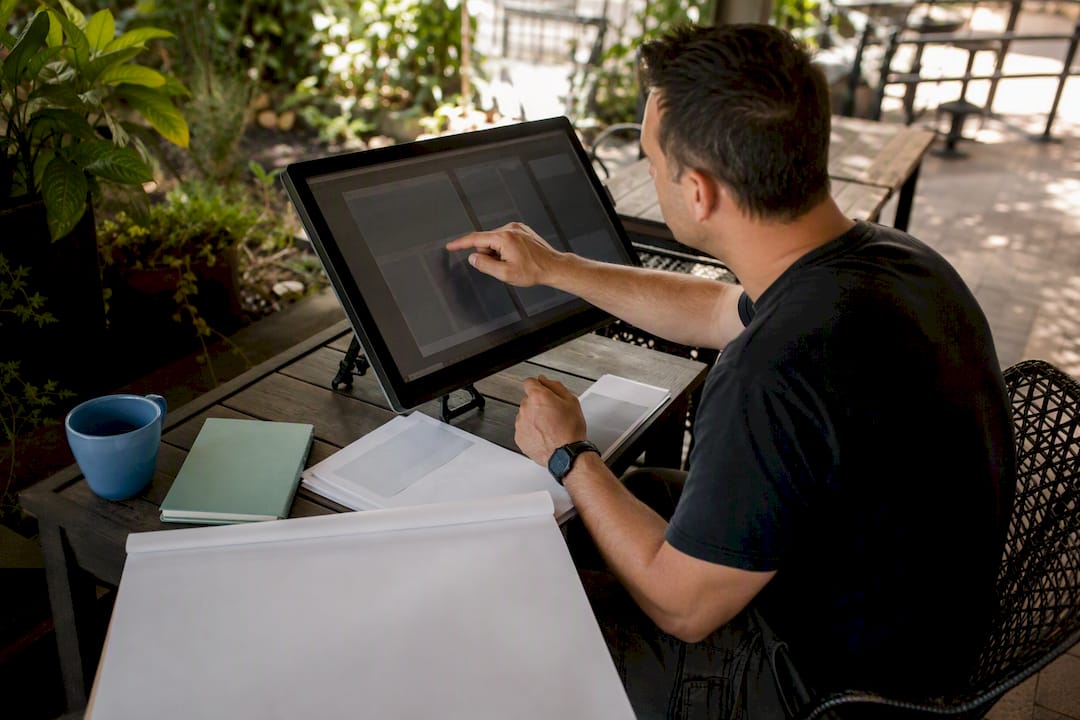 Hands adjusting web design layout grids