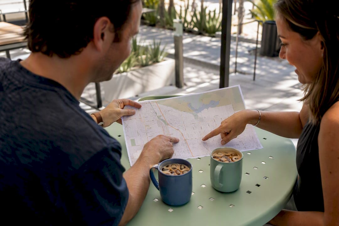 Hands pointing at local SEO map outdoors
