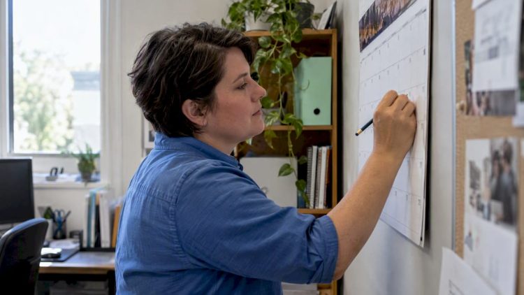 Owner marking website review deadlines on a calendar