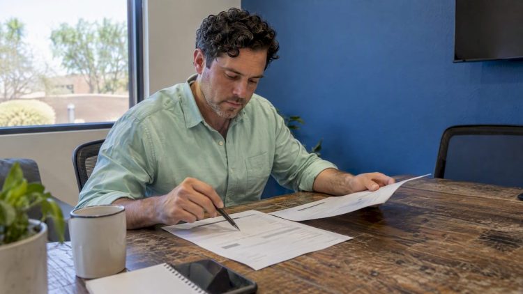 Small business owner compares redesign proposals