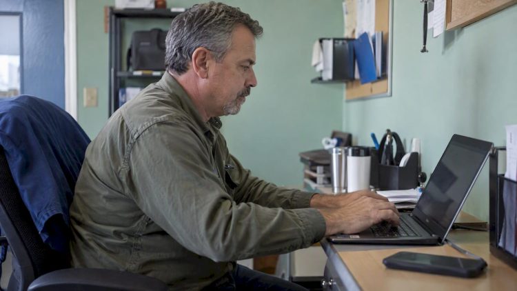 HVAC owner updating profile services on laptop