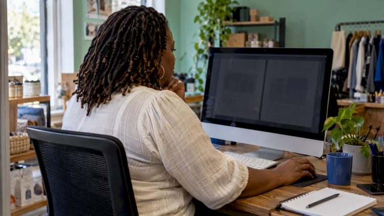 Business owner comparing two website page drafts